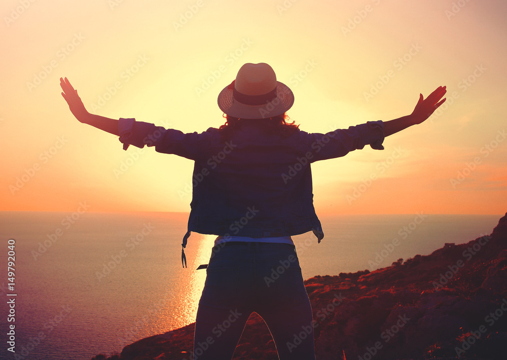 Fototapeta premium Young stylish carefree woman enjoying sunset at sea