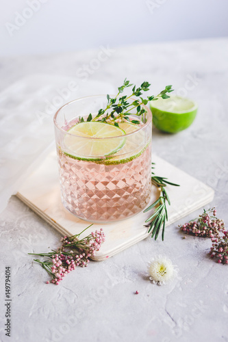 fresh homemade drink with flowers and lime on kitchen background