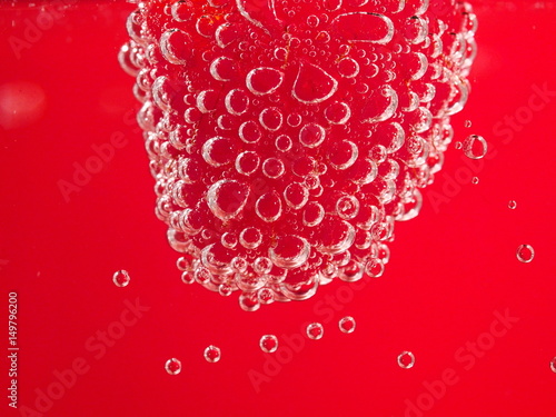 Fresh raspberry with bubbles on pink background. Nice fruit macro
