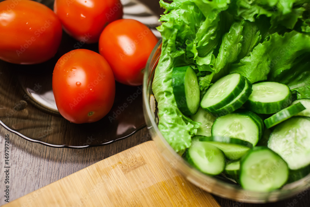 Fresh vegetables. sliced cucumber and tomato with lettuce Fresh vegetables. sliced cucumber and tomato with lettuce