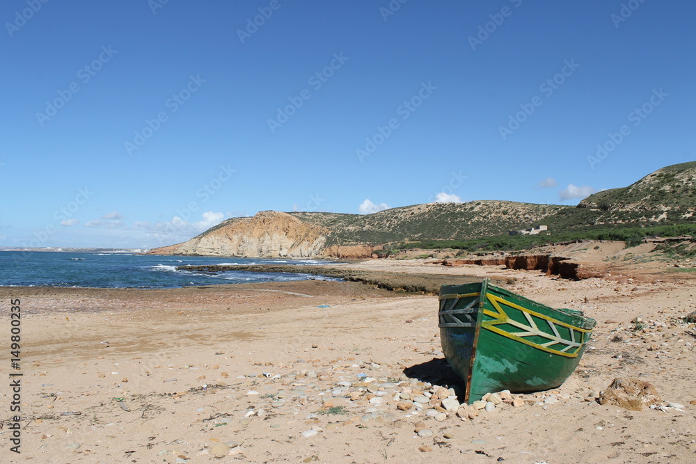 Coast in Morocco with green boat Coast in Morocco with green boat