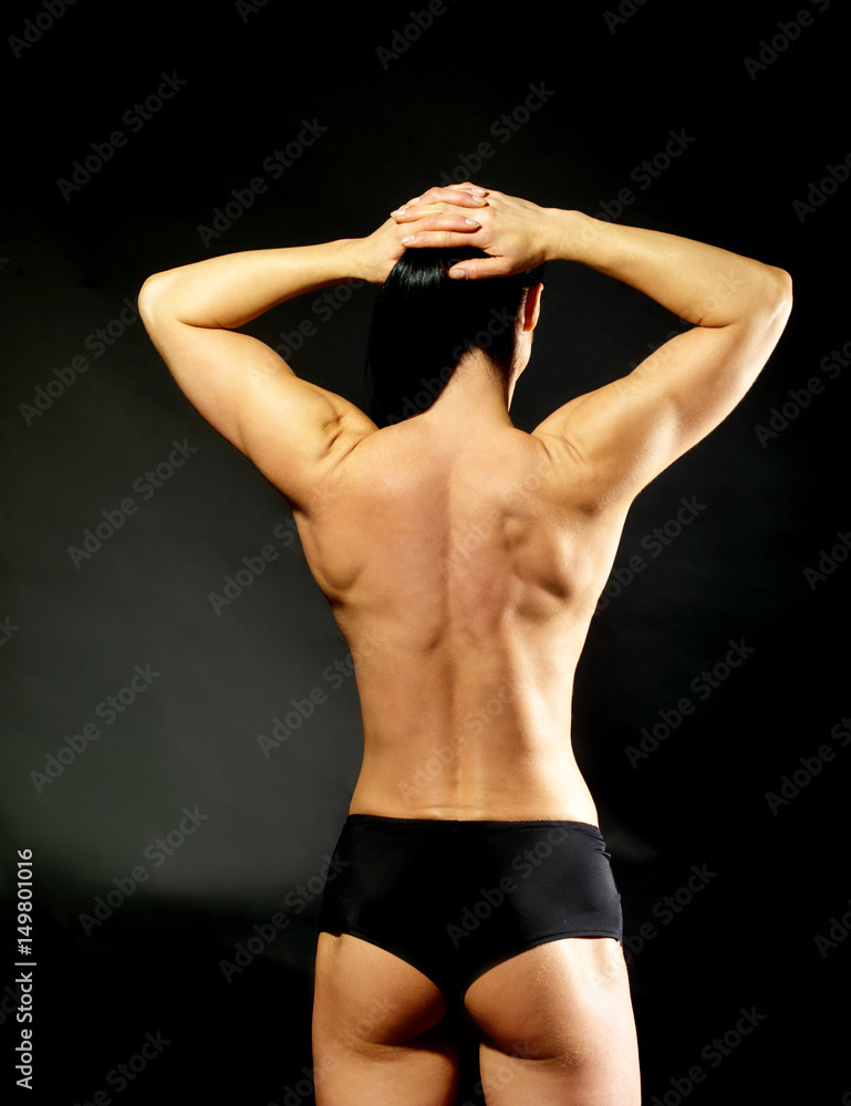 Naklejka premium Muscular bodybuilder woman showing her muscles.