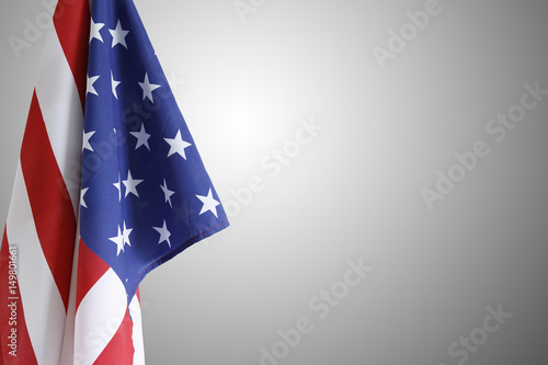 American flag in front of grey background