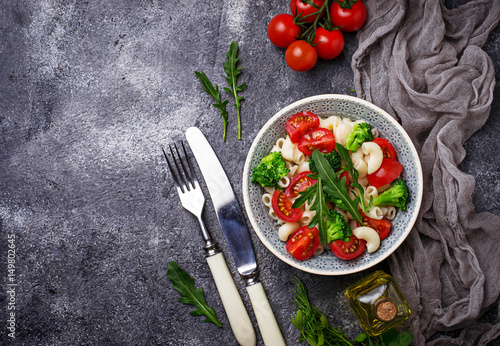 Salad with pasta, tomatoes, broccoli and arugula