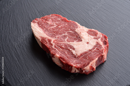 Fresh raw Prime Black Angus beef steak on stone background