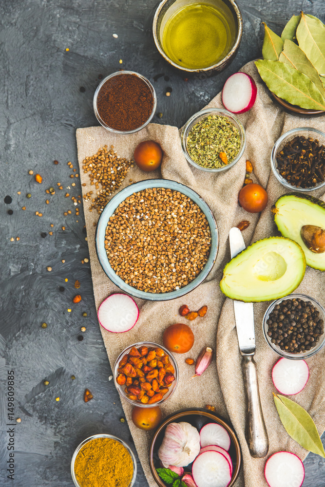 Buckwheat with vegetables, spices and herbs over dark rustic background. Top view Buckwheat with vegetables, spices and herbs over dark rustic background. Top view
