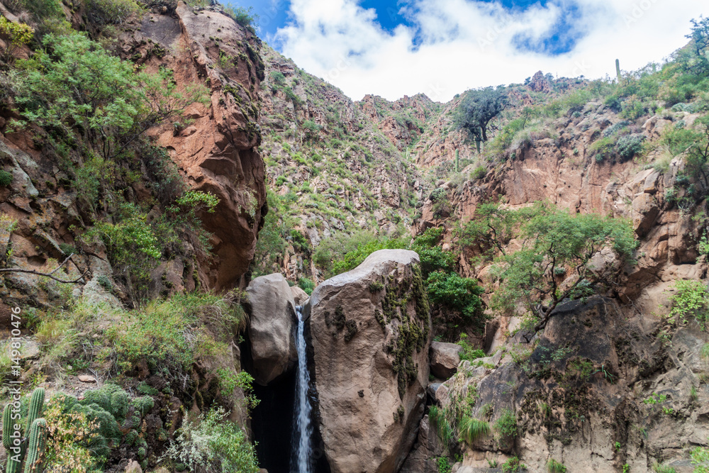 Tall waterfall in Quebrada del Colorado canyon near Cafayate, Argentina