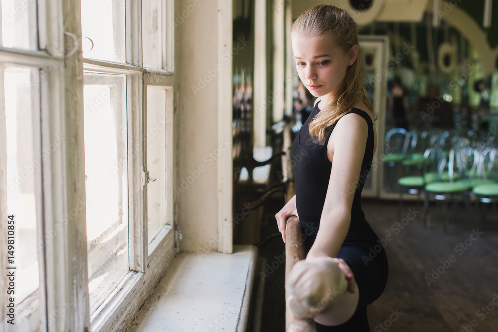 Attractive ballerina warming up in ballet class Attractive ballerina warming up in ballet class