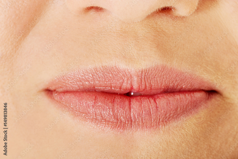 Fototapeta premium Part of face,young woman close up. Lips without makeup.