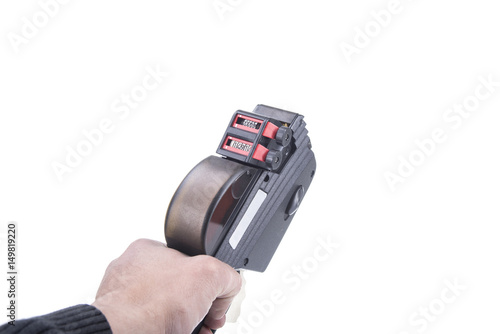 Price sticker gun in hand isolated on white