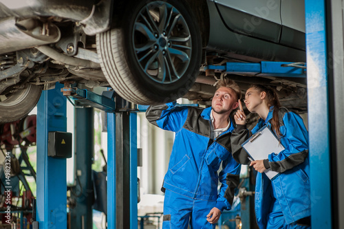 Man and woman in auto mechanics