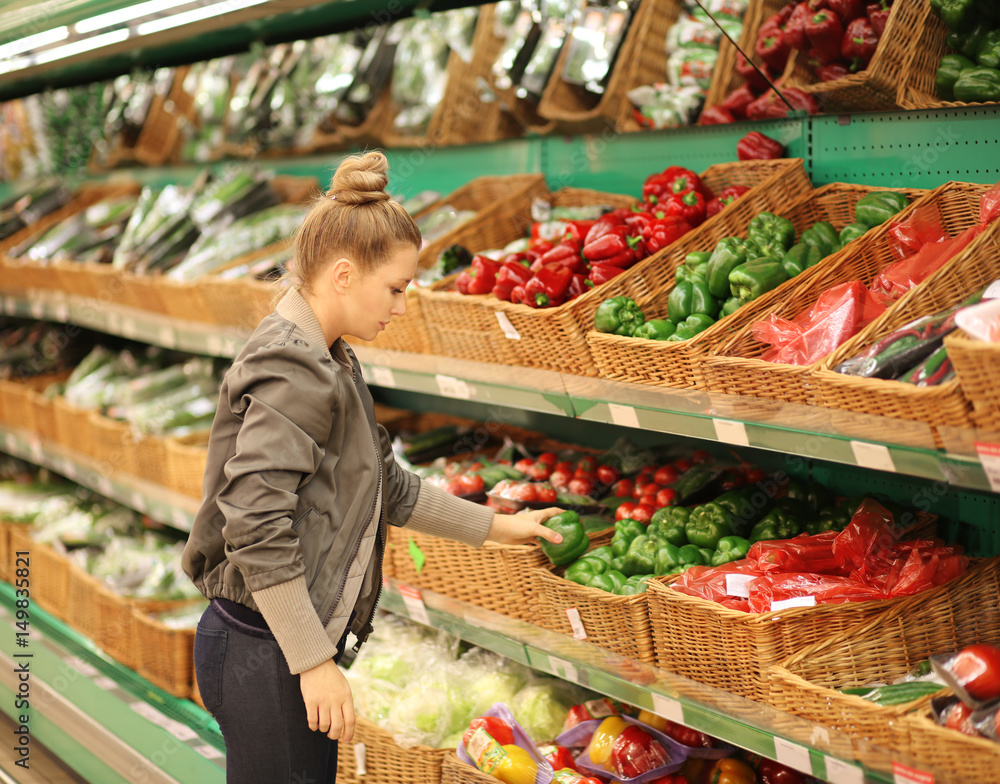 Middle-age woman buying vegetables at the market