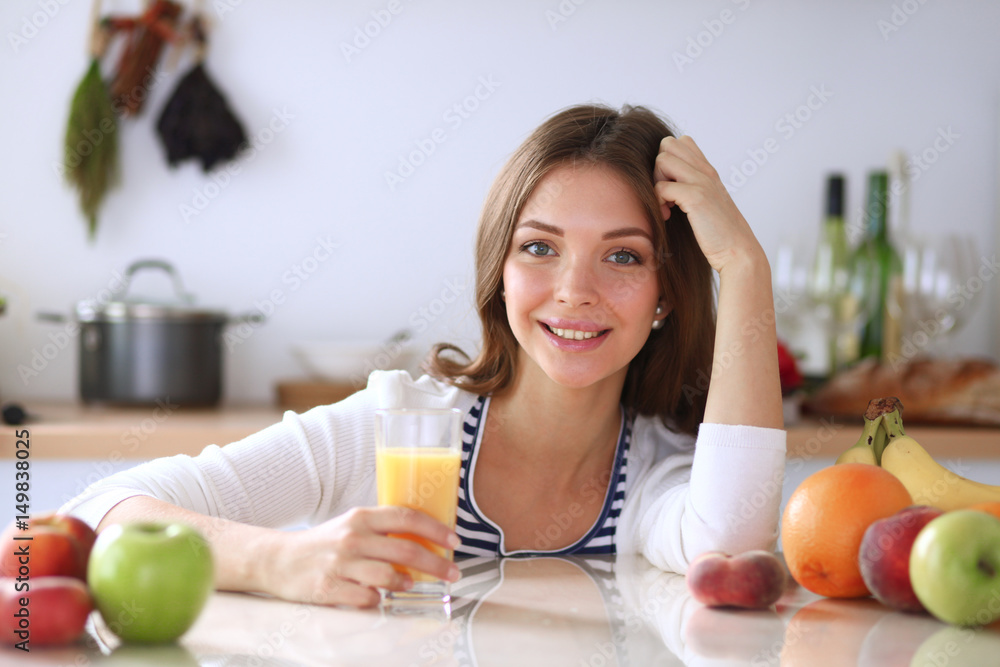 Young woman standing near desk in the kitchen Young woman standing near desk in the kitchen