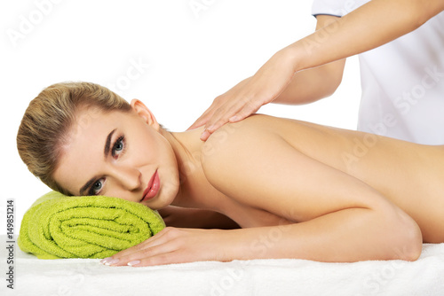Young smile woman lying on a massage table and has massage.
