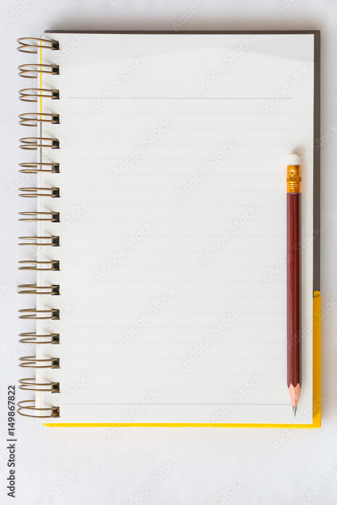 Pencil on notebook in white background Pencil on notebook in white background