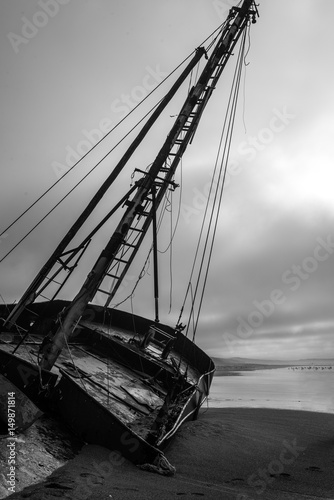 Shipwreck on beach in black and white