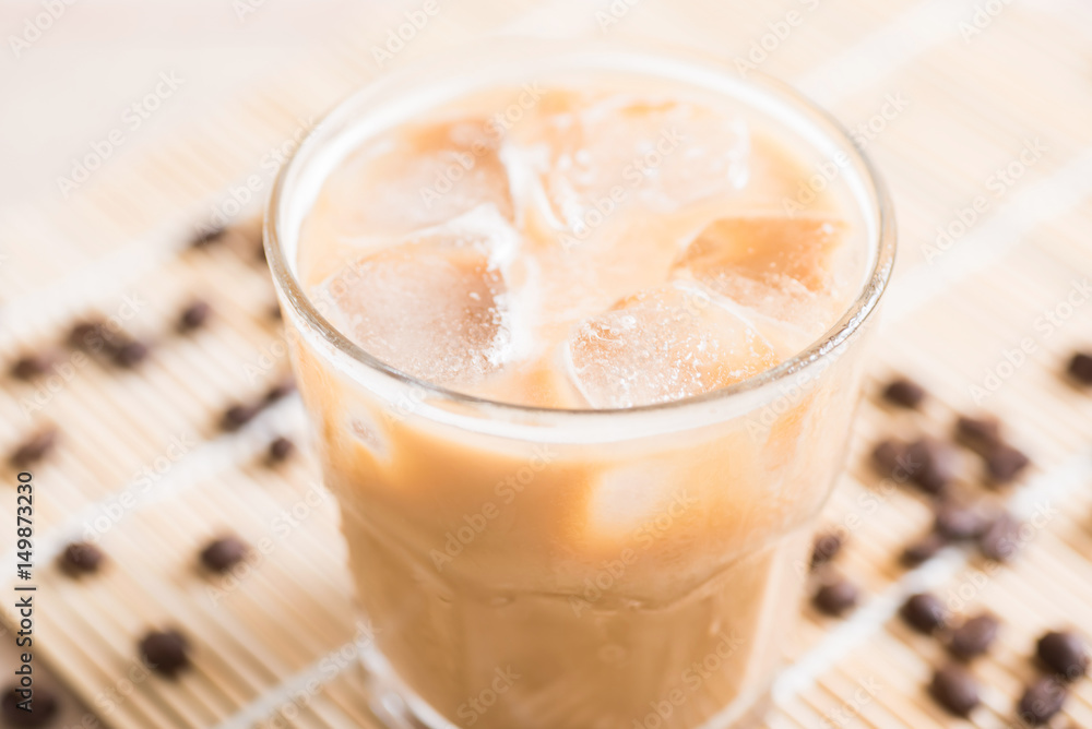 Glass of ice coffee with coffee bean on wooden background Glass of ice coffee with coffee bean on wooden background
