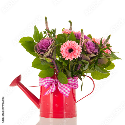 Watering can with bouquet flowers