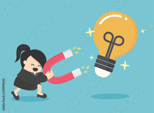 Business Woman Concept of attracting investments idea with magnet