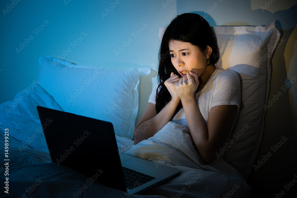 Pretty young woman watching horror movie Stock Photo | Adobe Stock