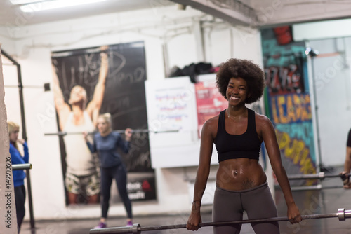 black woman lifting empty bar