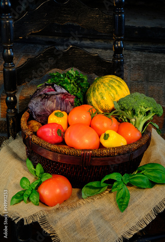 Vegetables in basket on sackcloth. Rustic style, dark background.