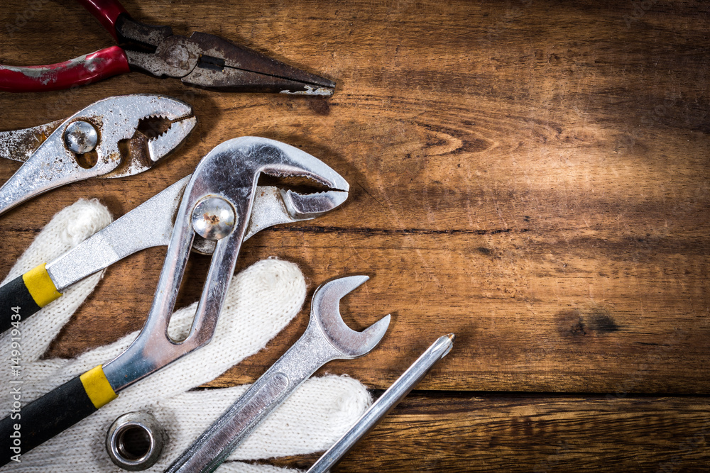 old & grunge set of hand tools on wood floor, copy space for home renovation background old & grunge set of hand tools on wood floor, copy space for home renovation background