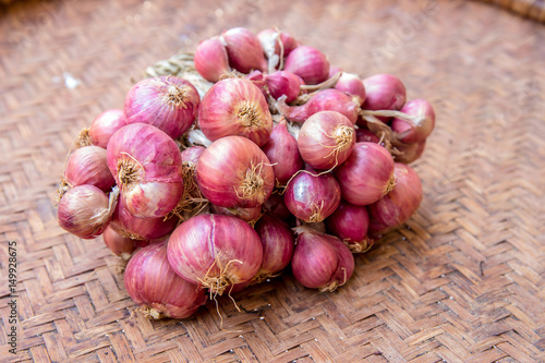 Shallots (Red Onion) on the vintage wicker or basketwork.