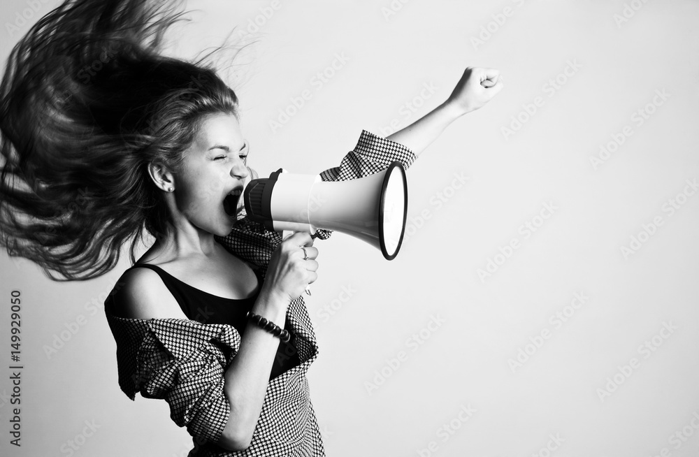 Young woman screaming in loudspeaker  - obrazy, fototapety, plakaty 