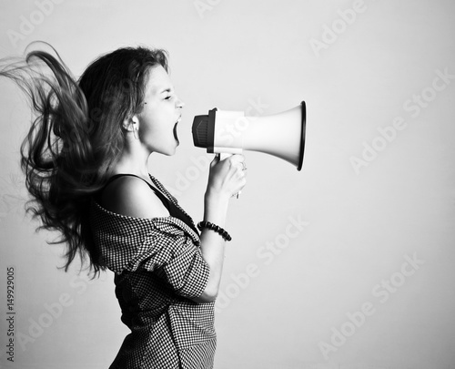 Young woman screaming in loudspeaker 
