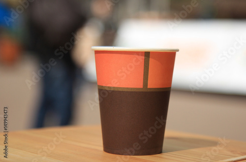 Colored paper cup on a blurrey background.