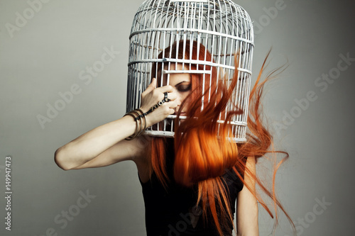 Fotografie, Tablou Beautiful redhead woman with birdcage