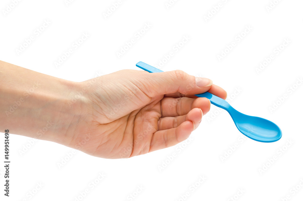woman hand holding small spoon for kids. woman hand holding small spoon for kids.
