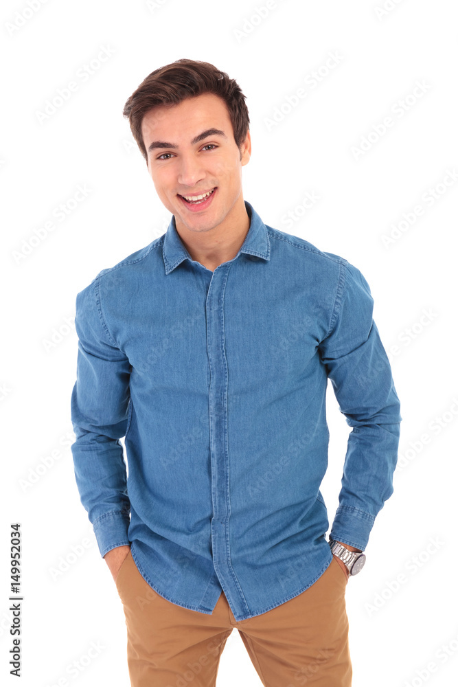 relaxed young casual man with hands in pockets is smiling relaxed young casual man with hands in pockets is smiling