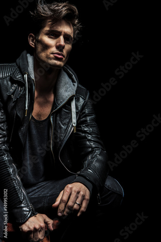 seated man in leather jacket dreaming away
