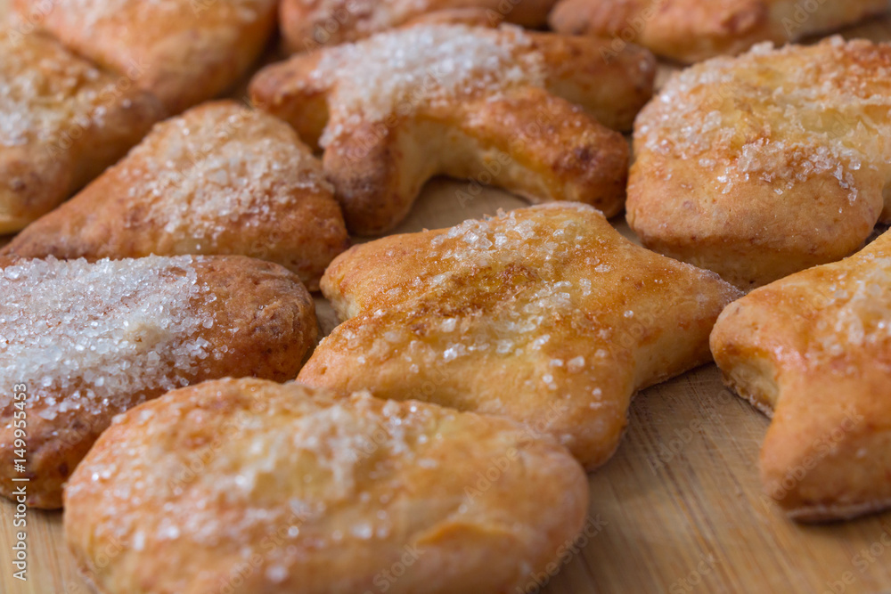 Cookies of different shapes with sugar for a Golden crust.