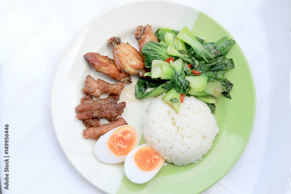 stir fried vegetables, Hard-boiled egg, Fried pork and Fried chicken wings with thai jasmine rice on dish. Thai food. stir fried vegetables, Hard-boiled egg, Fried pork and Fried chicken wings with thai jasmine rice on dish. Thai food.