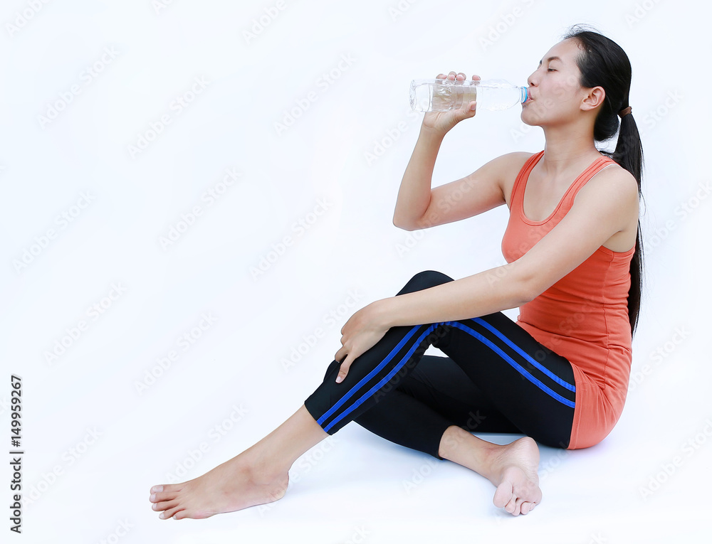 Healthy Woman Drinking Water after Workout, Fitness Girl in Workout Concept on white background. Healthy Woman Drinking Water after Workout, Fitness Girl in Workout Concept on white background.