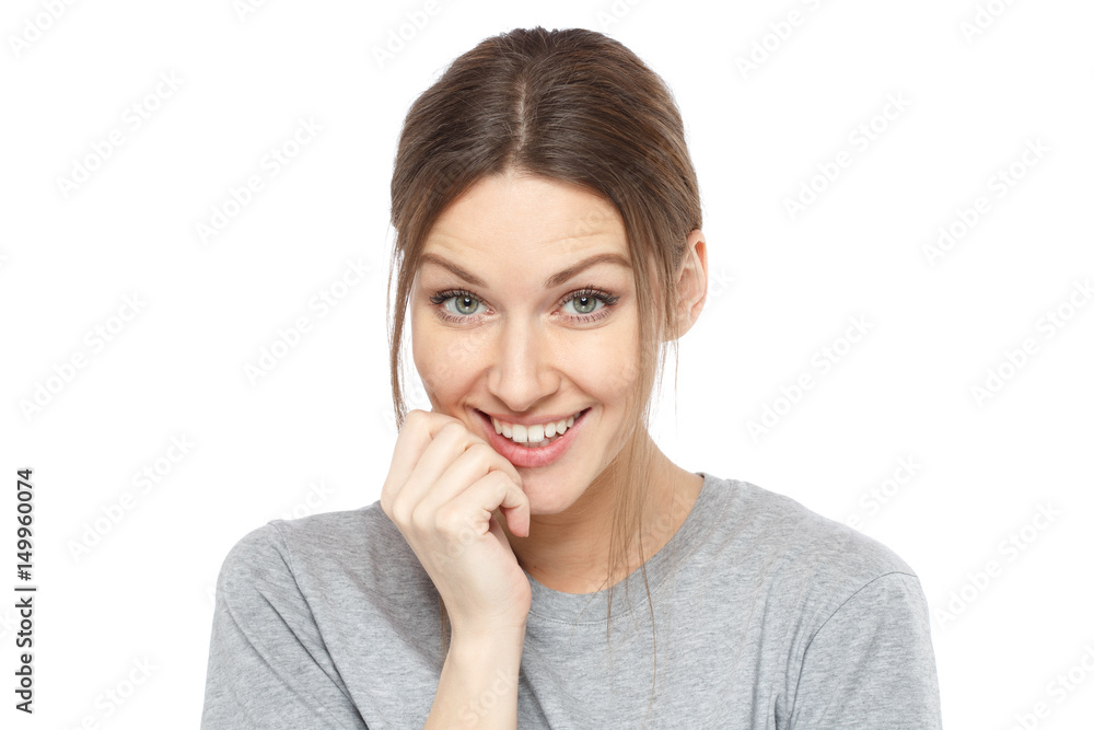 Indoor picture of good-looking European female isolated on white background smiling positively and timidly awaiting for reaction, answer, approval of ideas and pressing her hand to her cheek. Indoor picture of good-looking European female isolated on white background smiling positively and timidly awaiting for reaction, answer, approval of ideas and pressing her hand to her cheek.