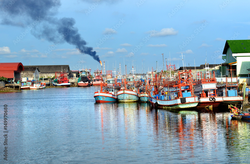 Group of wooden fishery boats stop at the estuary habour.