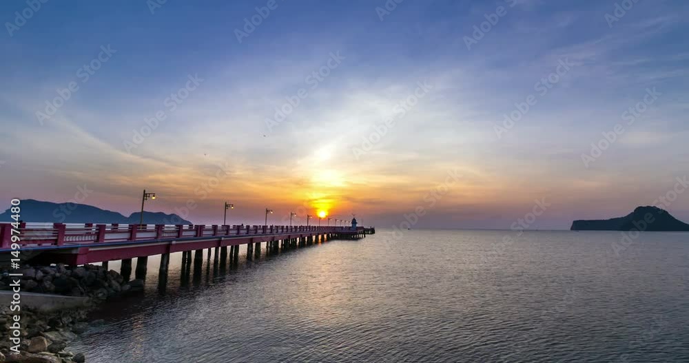 Sunrise over the sea with bridge and lighthouse Sunrise over the sea with bridge and lighthouse