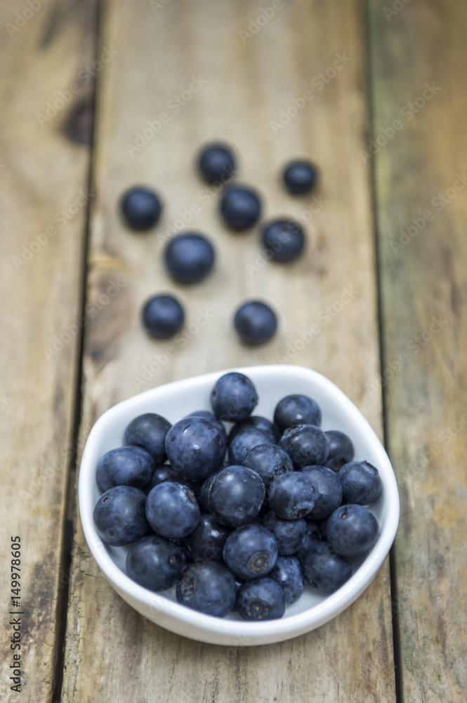 Freshly picked blueberries in wooden bowl. Juicy and fresh blueberries on rustic table Freshly picked blueberries in wooden bowl. Juicy and fresh blueberries on rustic table