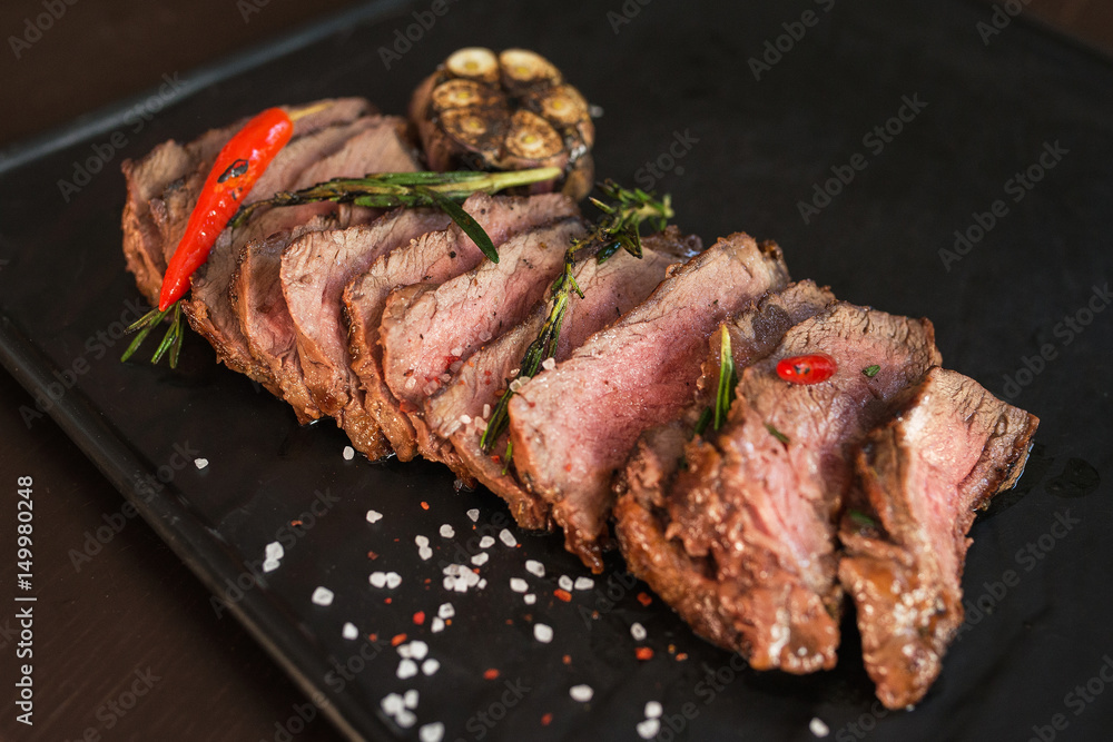 grilled beef steak on black board