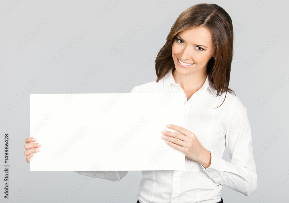 Businesswoman showing signboard, over grey Businesswoman showing signboard, over grey