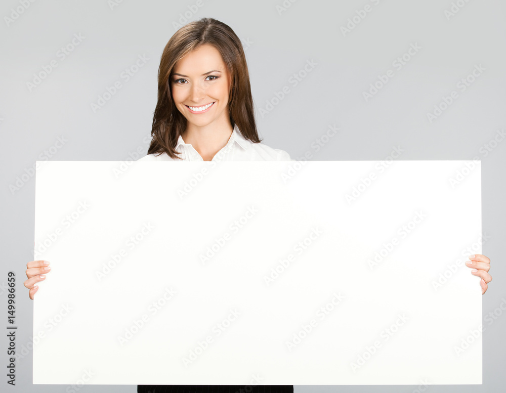 Businesswoman showing signboard, over grey Businesswoman showing signboard, over grey