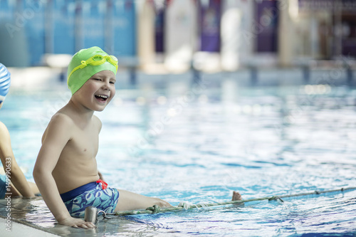 happy children kids group at swimming pool class learning to swim