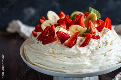 pavlova, meringue cake with strawberries and bananas photo