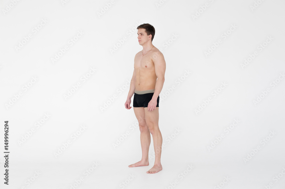 studio portrait young sexy men bodybuilder athlete, with a bare torso, Standing in full length on a white background in underwear underwear, Belt is photographed, gold chain with a cross on the neck