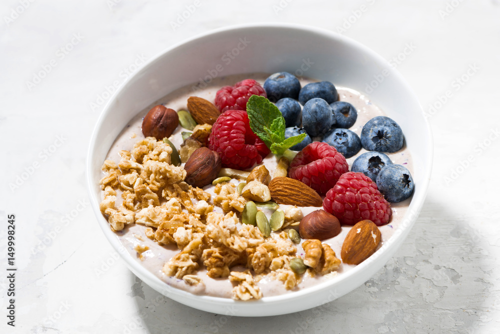 muesli with yogurt and berries for breakfast on white table muesli with yogurt and berries for breakfast on white table