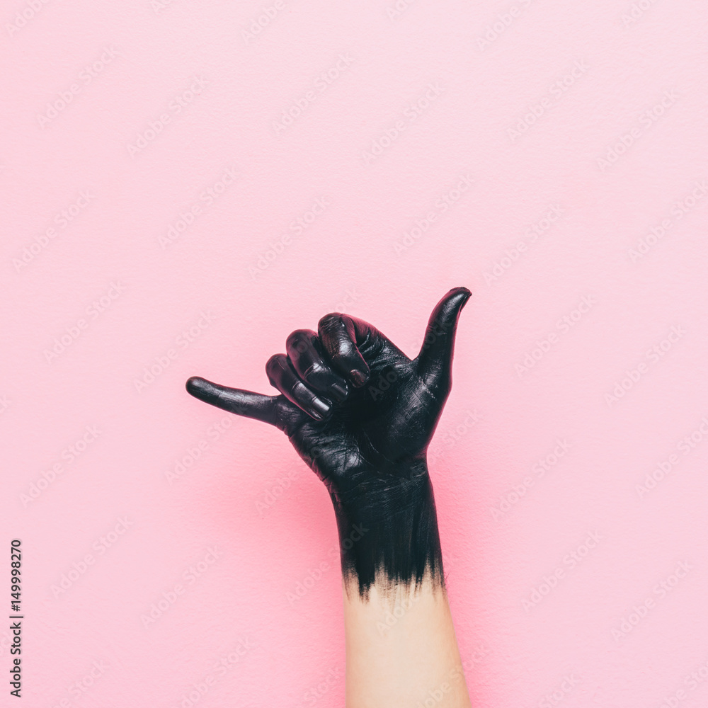 surf Shaka gesture by black painted hand on pink background. minimal style of summer - obrazy, fototapety, plakaty 